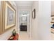 Hallway view leading to a bathroom, with decorative art and table at 922 Cancun Ct, The Villages, FL 32159