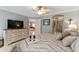 Relaxing main bedroom featuring stylish decor, neutral tones, and en-suite bathroom access at 922 Cancun Ct, The Villages, FL 32159