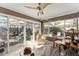 Light-filled sunroom featuring tile floors, a ceiling fan, and sliding glass doors leading to an outdoor patio at 922 Cancun Ct, The Villages, FL 32159