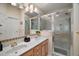 Bathroom featuring double sinks and shower with patterned tile accents at 932 Medira Dr, The Villages, FL 32159