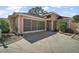 Charming single Gathering home featuring a screened in garage, concrete driveway, and meticulously manicured landscaping at 932 Medira Dr, The Villages, FL 32159