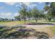 Scenic golf course with manicured greens, mature trees, and a walking path on a sunny day at 932 Medira Dr, The Villages, FL 32159