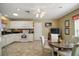 Bright and airy kitchen with white cabinetry, breakfast nook, and modern appliances, perfect for casual dining at 932 Medira Dr, The Villages, FL 32159