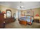 Well-lit main bedroom with a four poster bed and matching nightstands and dressers at 932 Medira Dr, The Villages, FL 32159