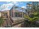 Relaxing backyard with a screened in patio including a hot tub and an enclosed sunroom on a stone area at 932 Medira Dr, The Villages, FL 32159