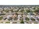 An aerial view showcasing a peaceful residential neighborhood with tree-lined streets and diverse home styles at 17454 Se 81St Newberry Ct, The Villages, FL 32162