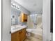 Bathroom featuring a single sink vanity and a shower with curtain rod at 17454 Se 81St Newberry Ct, The Villages, FL 32162