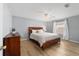 Bedroom with light wood flooring, a ceiling fan, and a window at 17454 Se 81St Newberry Ct, The Villages, FL 32162