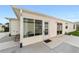 Exterior view of the back of home showing sunroom addition and sliding glass door access at 17454 Se 81St Newberry Ct, The Villages, FL 32162
