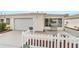 Charming home featuring a one-car garage, white picket fence, and inviting, enclosed front porch at 17454 Se 81St Newberry Ct, The Villages, FL 32162