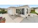 Home featuring a one-car garage and inviting sunroom addition for extra living space at 17454 Se 81St Newberry Ct, The Villages, FL 32162