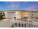 Charming home featuring a one-car garage, white picket fence, and inviting, enclosed front porch at 17454 Se 81St Newberry Ct, The Villages, FL 32162