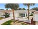 Inviting single-story home featuring a cozy sunroom, attached garage, and a white picket fence at 17454 Se 81St Newberry Ct, The Villages, FL 32162