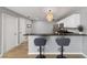 Kitchen featuring white cabinets, dark granite countertops, stainless steel appliances, and breakfast bar at 17454 Se 81St Newberry Ct, The Villages, FL 32162