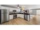 Modern kitchen with stainless steel appliances and white cabinets and black countertop at 17454 Se 81St Newberry Ct, The Villages, FL 32162