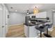 Kitchen featuring white cabinets, dark granite countertops, stainless steel appliances, and breakfast bar at 17454 Se 81St Newberry Ct, The Villages, FL 32162