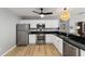 Kitchen featuring white cabinets, dark granite countertops, and stainless steel appliances at 17454 Se 81St Newberry Ct, The Villages, FL 32162