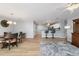 Open living room featuring wood flooring, dining table, and breakfast bar at 17454 Se 81St Newberry Ct, The Villages, FL 32162