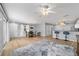Open living room with wood floors, dining table, breakfast bar, and lots of natural light at 17454 Se 81St Newberry Ct, The Villages, FL 32162