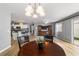 Living room features a dining area, wood flooring and a view into the kitchen at 17454 Se 81St Newberry Ct, The Villages, FL 32162