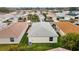 Aerial perspective showcases a property with a pristine backyard, neat landscaping, and well-maintained surroundings at 17454 Se 81St Newberry Ct, The Villages, FL 32162