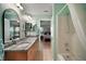 Bathroom featuring double sinks, granite counters, and a shower-tub combo at 11053 Se 174Th Loop, Summerfield, FL 34491
