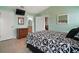 Comfortable bedroom with tile flooring, dresser, and en-suite bathroom at 11053 Se 174Th Loop, Summerfield, FL 34491