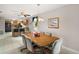 Open dining area featuring tile floors, ceiling fan, and direct access to a modern kitchen at 11053 Se 174Th Loop, Summerfield, FL 34491