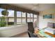 Bright sunroom with large windows, ceiling fan, and comfortable seating, perfect for enjoying the view at 11053 Se 174Th Loop, Summerfield, FL 34491