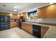 Bright kitchen with granite countertops, stainless steel appliances, and light wood cabinetry at 11053 Se 174Th Loop, Summerfield, FL 34491