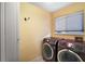 Laundry room featuring front load washer and dryer at 11053 Se 174Th Loop, Summerfield, FL 34491