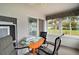 Bright and inviting sun room with panoramic views of the backyard and comfortable seating at 11053 Se 174Th Loop, Summerfield, FL 34491