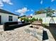 Inviting backyard with a cozy fire pit area, perfect for outdoor entertaining and relaxation at 1209 Demoiselle St, Groveland, FL 34736