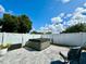 Private backyard features a hot tub, patio with room for seating, and a white privacy fence at 1209 Demoiselle St, Groveland, FL 34736