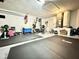 Wide angle shot of basement area featuring gym equipment, concrete walls, and flooring mats at 1209 Demoiselle St, Groveland, FL 34736