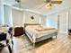 Bedroom featuring hard wood floors, ceiling fan, curtains and plenty of space at 1209 Demoiselle St, Groveland, FL 34736