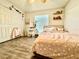 Cozy bedroom featuring wood flooring, large closet, and a vanity area at 1209 Demoiselle St, Groveland, FL 34736