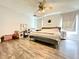 Comfortable bedroom with hardwood floors, large windows, and a ceiling fan for a cozy ambiance at 1209 Demoiselle St, Groveland, FL 34736