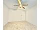 Empty bedroom with tile flooring and a ceiling fan and fixture in a neutral tone at 1209 Demoiselle St, Groveland, FL 34736