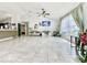 Spacious living room with tile flooring, modern decor, and large windows offering abundant natural light at 1209 Demoiselle St, Groveland, FL 34736