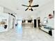 Spacious living room featuring vaulted ceilings, light tile floors, and an open floor plan to the kitchen at 1209 Demoiselle St, Groveland, FL 34736
