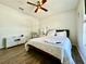 Bedroom with wood-look floors, a ceiling fan, and a comfortable bed with white linens at 1209 Demoiselle St, Groveland, FL 34736