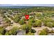Aerial view of the property highlighting the surrounding neighborhood, mature trees, and proximity to the lake at 1212 Windy Bluff Dr, Minneola, FL 34715