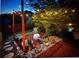 Backyard seating area illuminated by string lights creating an inviting and peaceful outdoor atmosphere at 1212 Windy Bluff Dr, Minneola, FL 34715