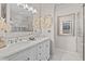 Bathroom featuring a double vanity, marble countertops, tile backsplash, and modern lighting fixtures at 1212 Windy Bluff Dr, Minneola, FL 34715