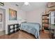 Cozy bedroom with hardwood floors, a ceiling fan, and simple furnishings at 1212 Windy Bluff Dr, Minneola, FL 34715