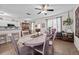 Bright dining space open to the kitchen featuring a table with decorative centerpiece and seating for six at 1212 Windy Bluff Dr, Minneola, FL 34715