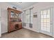 Dining area features a wood cabinet and bar area, a window, and an exterior door at 1212 Windy Bluff Dr, Minneola, FL 34715