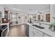 Open kitchen showcasing white countertops, stainless steel appliances, and tile flooring with an adjacent dining area at 1212 Windy Bluff Dr, Minneola, FL 34715