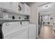 Functional laundry room with modern appliances and ample cabinet storage at 1212 Windy Bluff Dr, Minneola, FL 34715